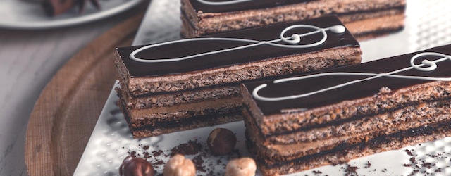 Chocolate hazelnut slice with ornate icing patterns